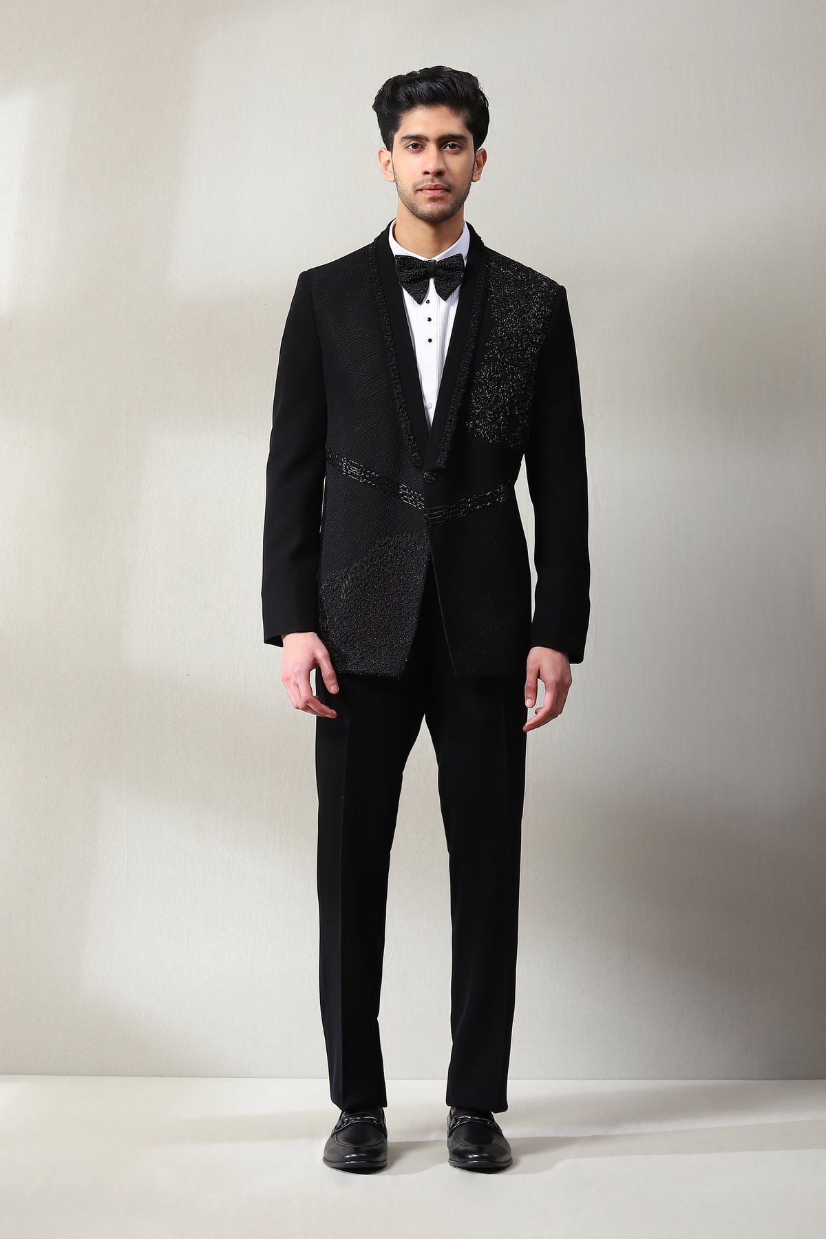 This black tuxedo is adorned with bead hand and zardosi work.