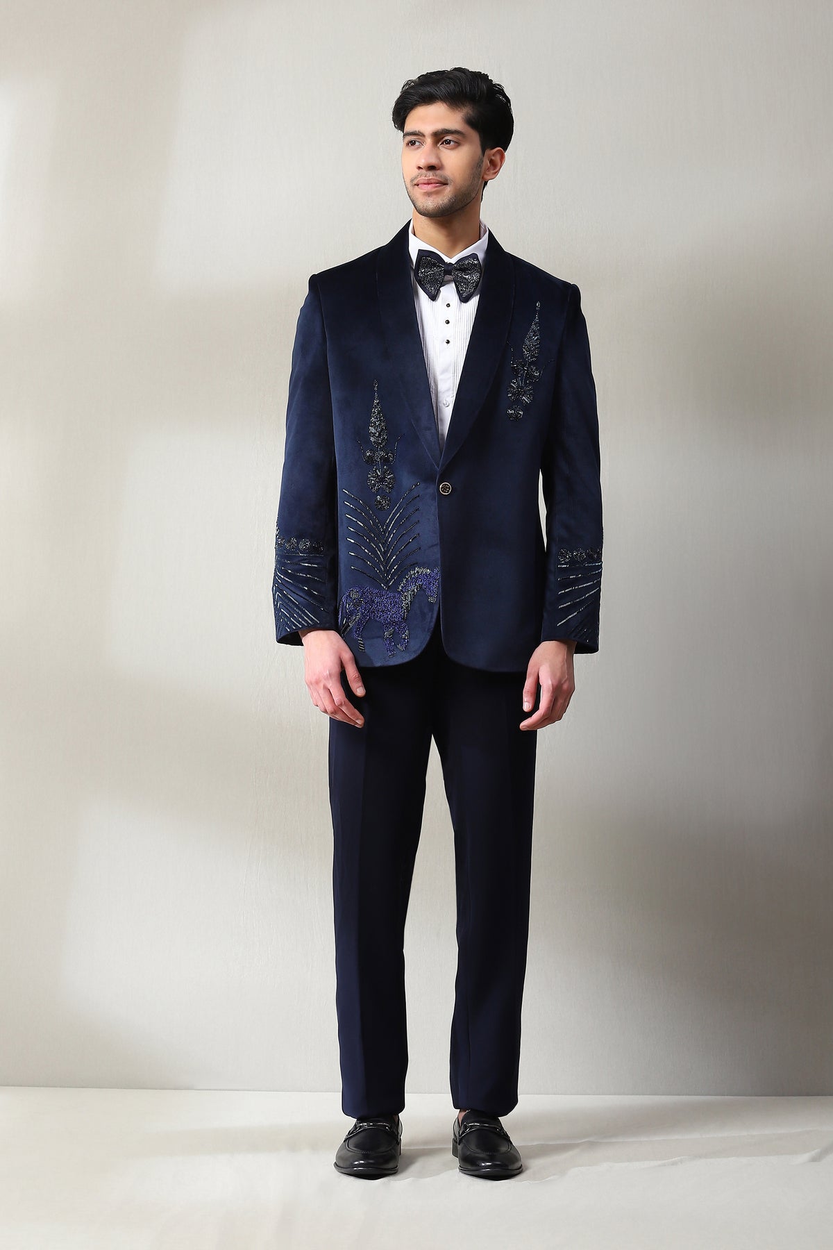 This velvet silk navy blue tuxedo is adorned with bead sarvoski and hand work