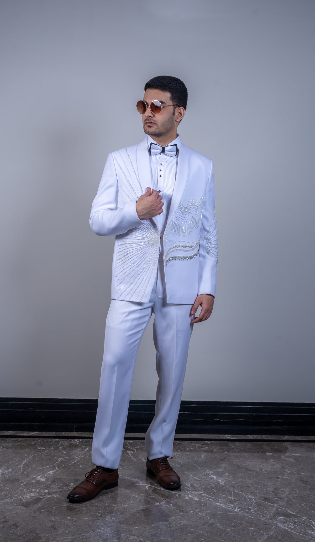 This ivory italian silk stylish suit is adorned with beads and stone work