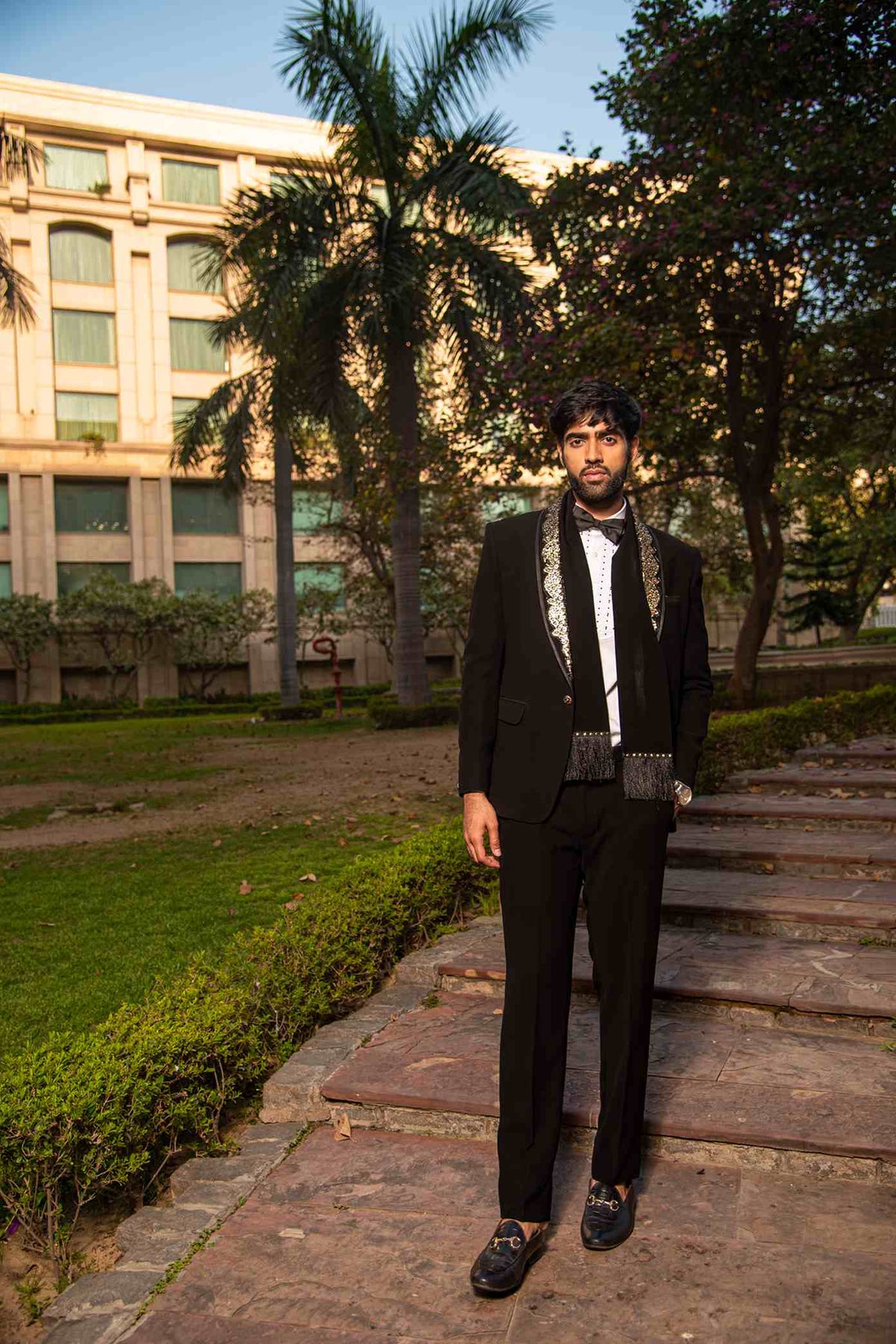 Black Embellished Tuxedo With Metal Work On The Lapel And A Matching Scarf