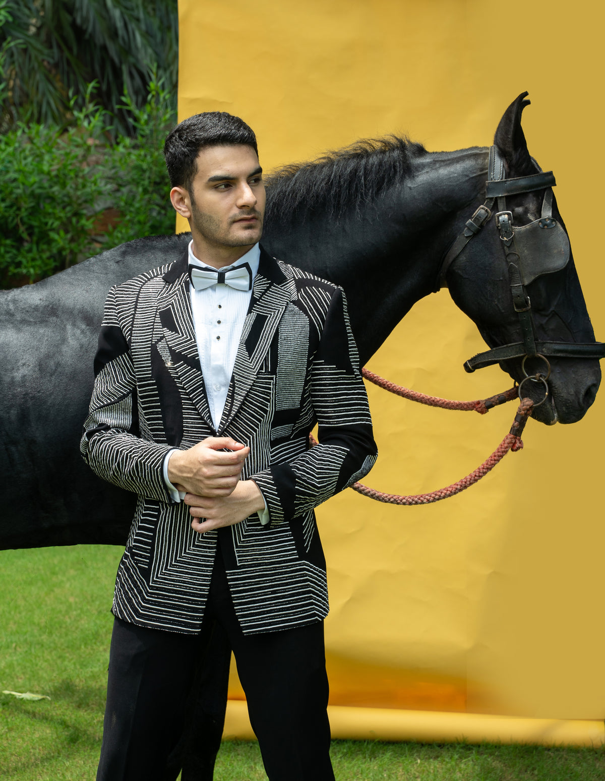 This black silk stylish suit is adorned with white stripes